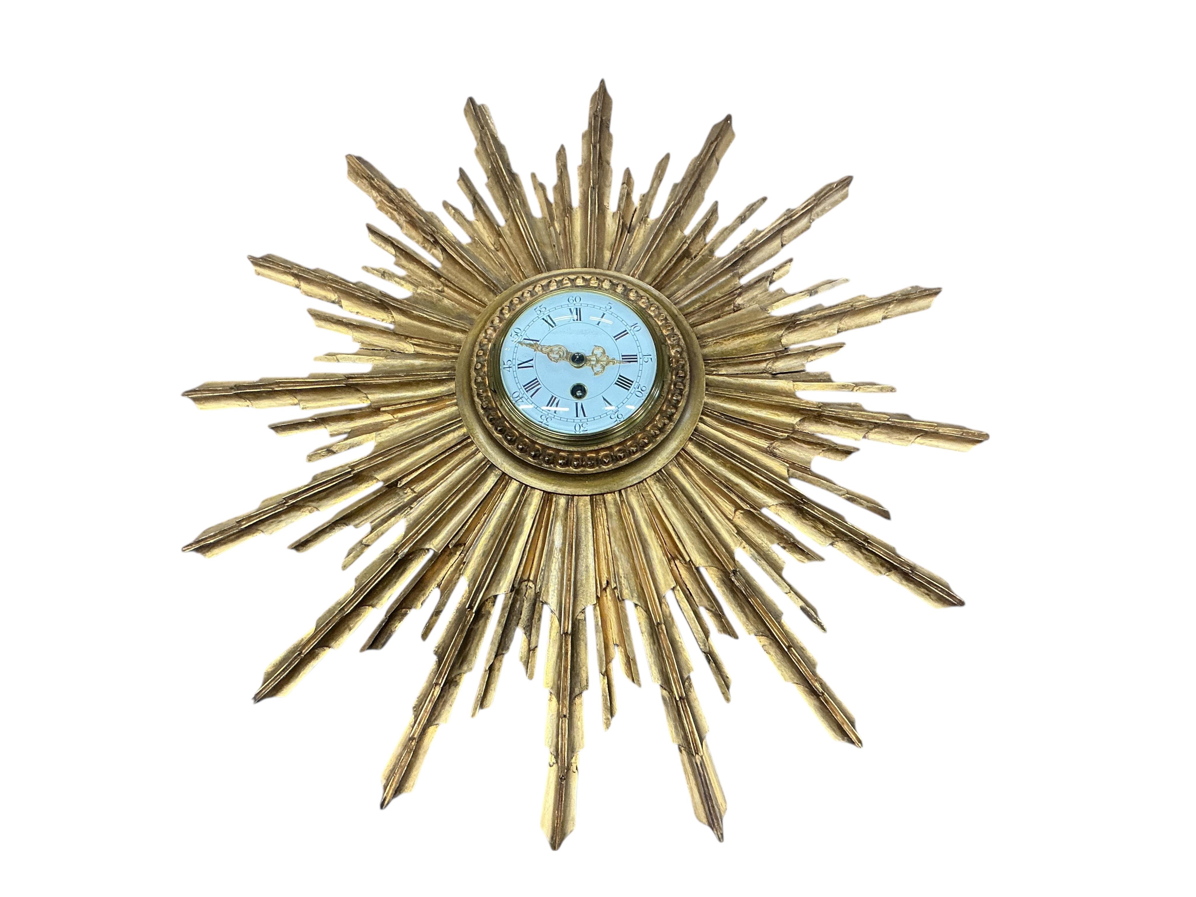 An early 20th century carved giltwood starburst wall timepiece, diameter 62cm